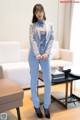 A woman in a blue suit standing in a living room.